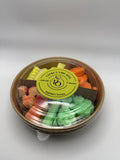 Round container of colorful wax melts on a white background