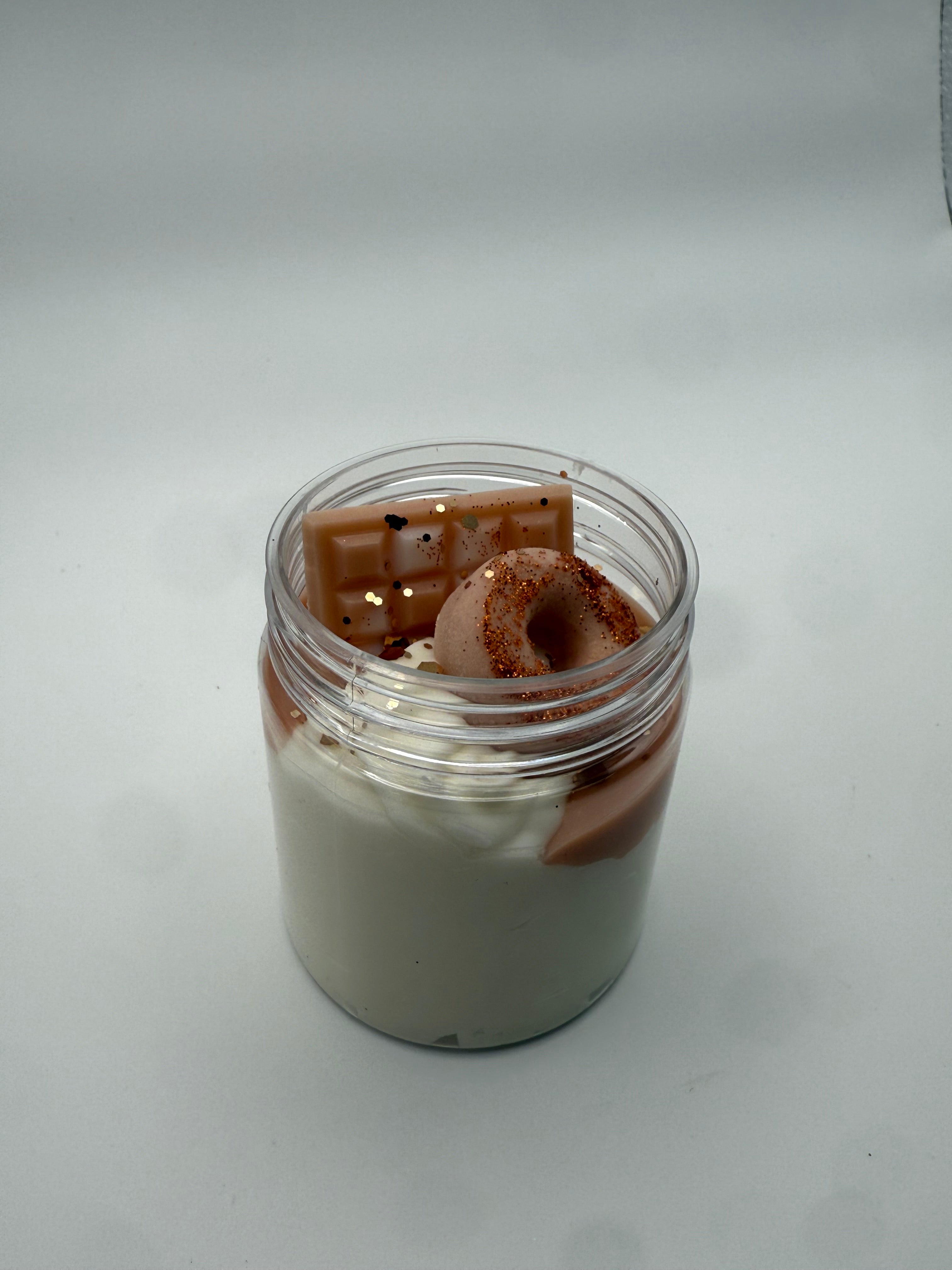 Small container with a brown cylindrical object inside on a white background