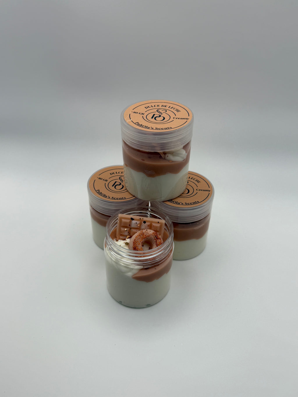 Set of small jars with brown contents on a white background