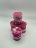 Three pink and white containers with decorative elements on a light gray background