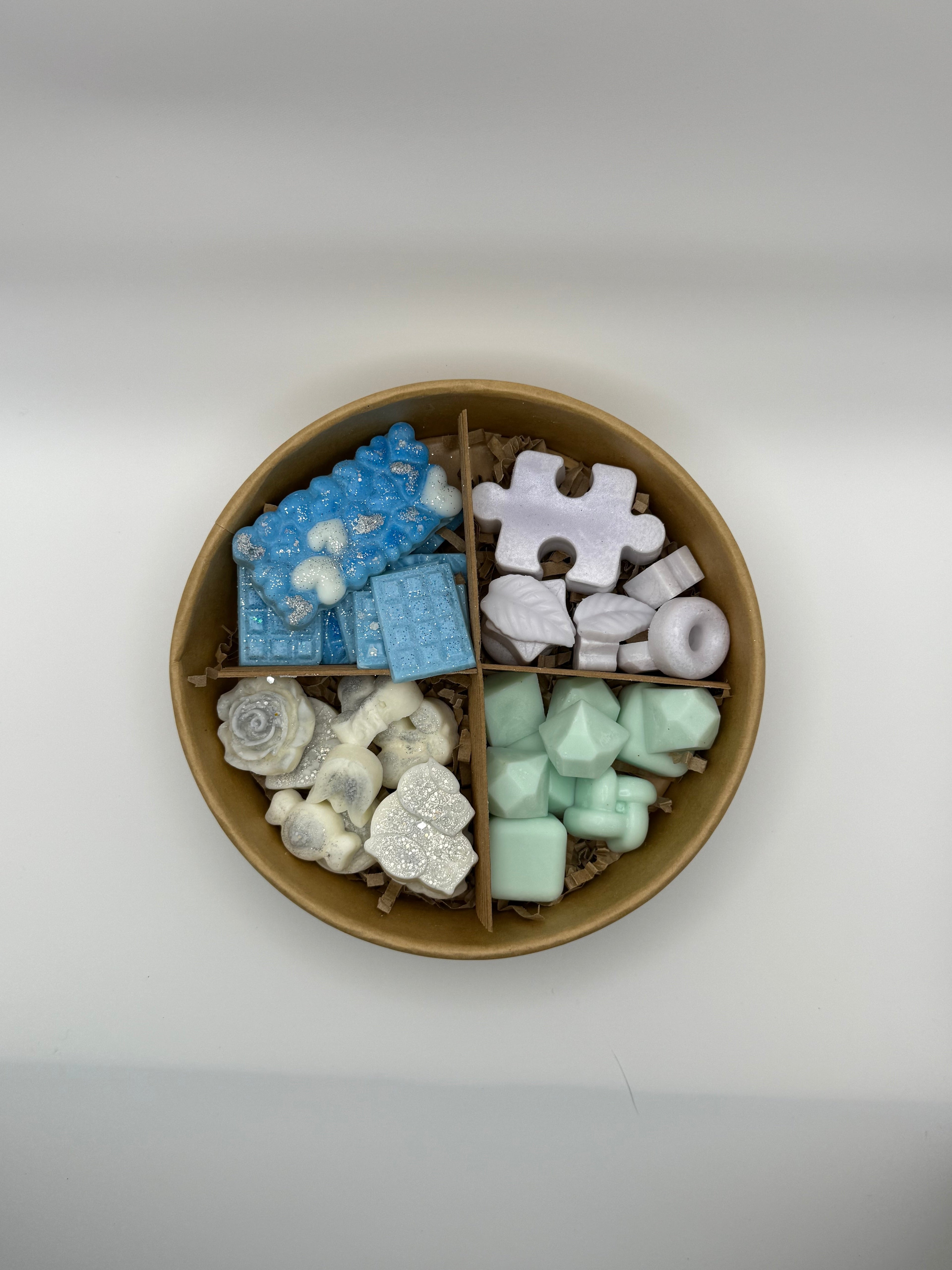 Round container of colorful wax melts on a white background