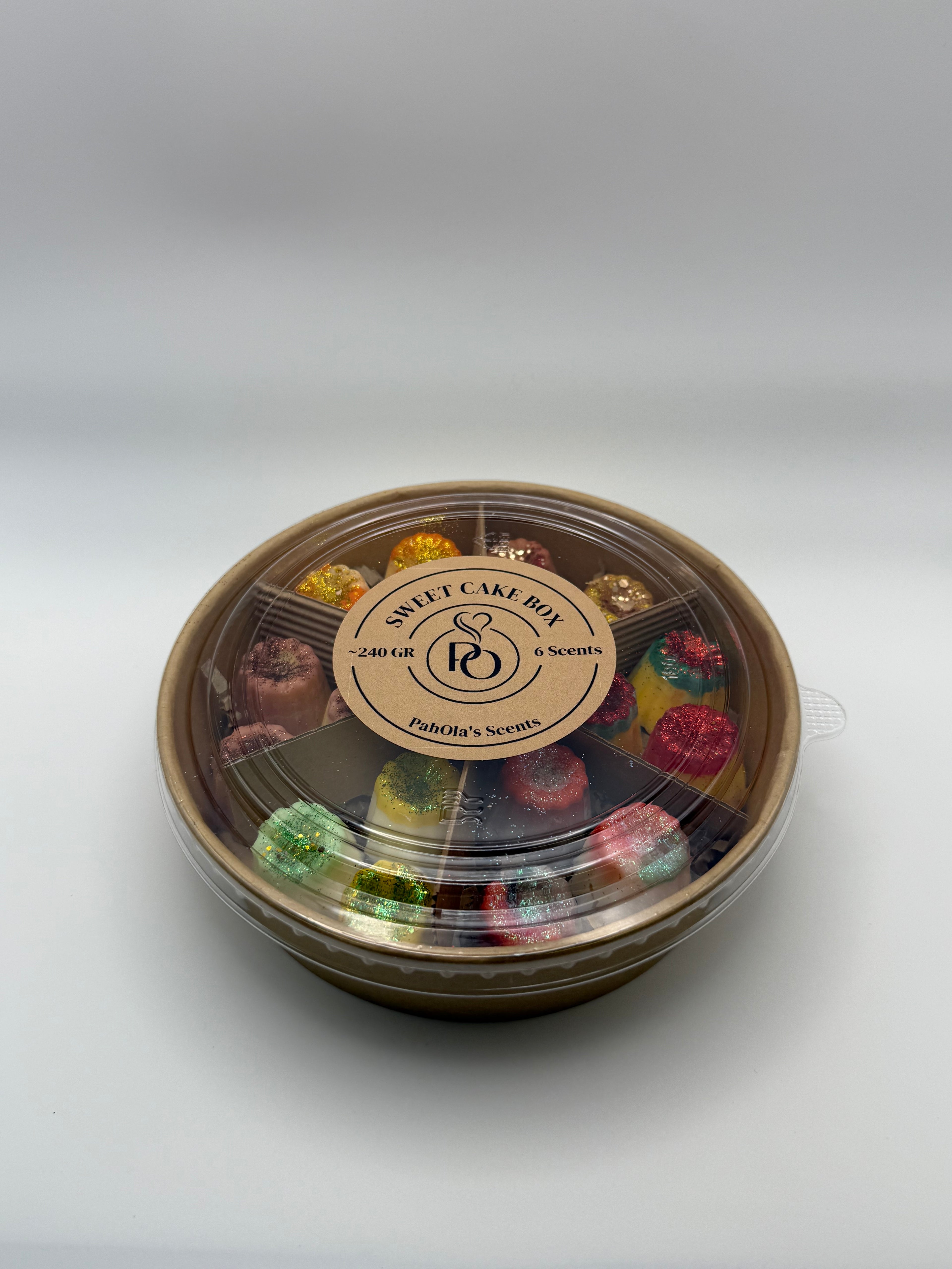 Round container of colorful wax melts on a white background